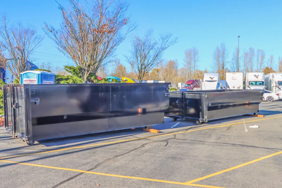 Professional dumpster rental service with roll-off container on residential driveway in West Haven-Sylvan